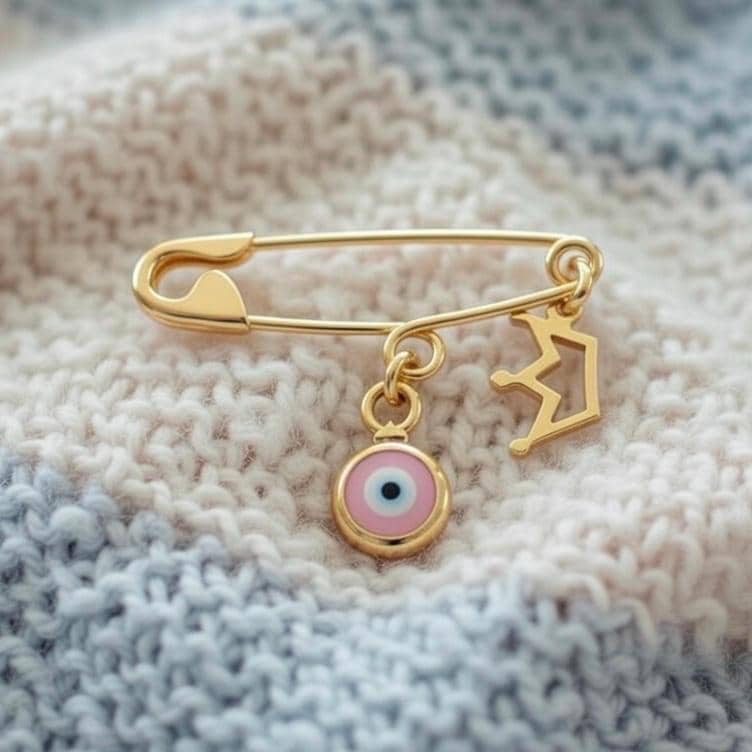 Gold Evil Eye Baby Safety Christening Pin Brooch with Crown Charm on a baby blanket - 24jewels