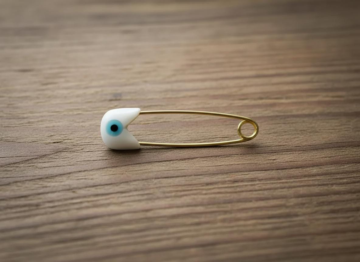 Gold Evil Eye Baby Pin Brooch-Protection Newborn Gift on Wooden Surface - 24jewels