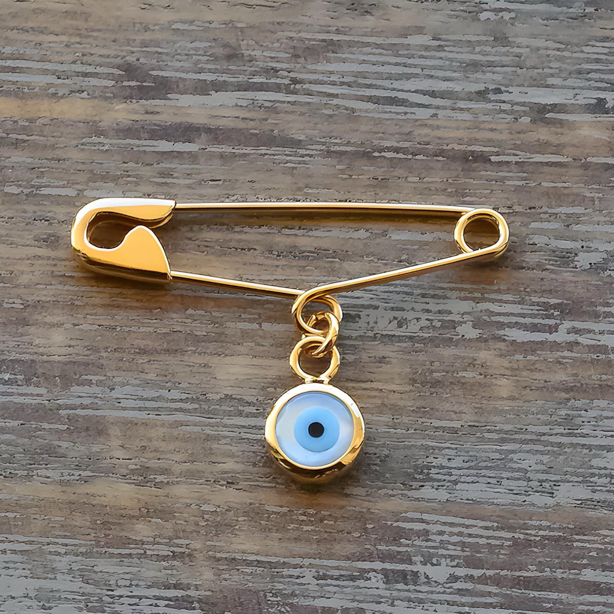 Gold Evil Eye Safety Pin baby Brooch - Handmade Baby Protection Charm on wooden surface - 24jewels