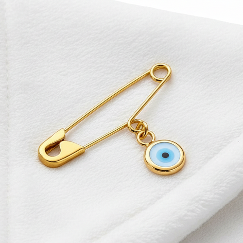 Gold Evil Eye Safety Pin Baby Brooch - Handmade Baby Protection Charm on white smooth surface  - 24jewels