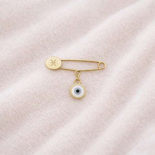 Gold Evil Eye Zodiac Safety Pin Brooch – Baby Gift on pink blanket
