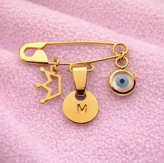 Gold Evil Eye Baby Pin Personalised Brooch With Crown Charm on a pink baby blanket - 24jewels