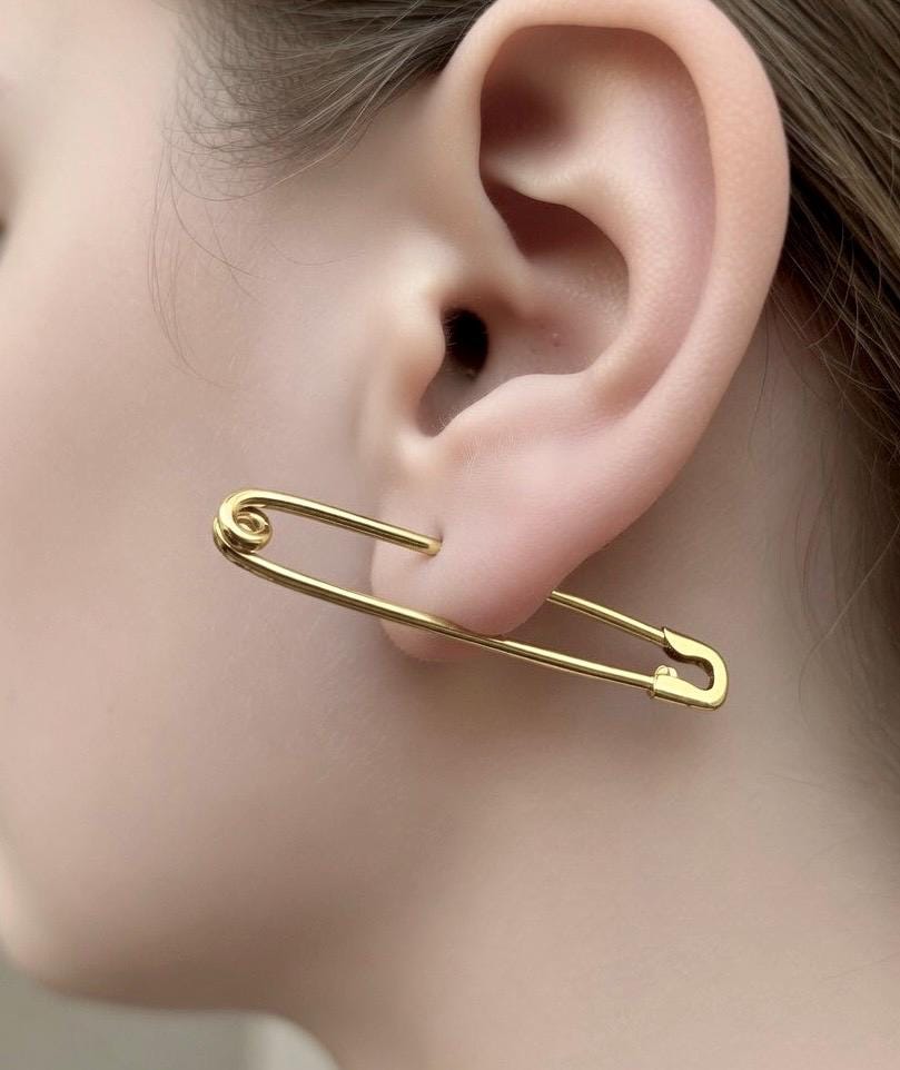 Gold-plated 1.75-inch long safety pin earring worn on earlobe, 16 gauge thick minimalist design.