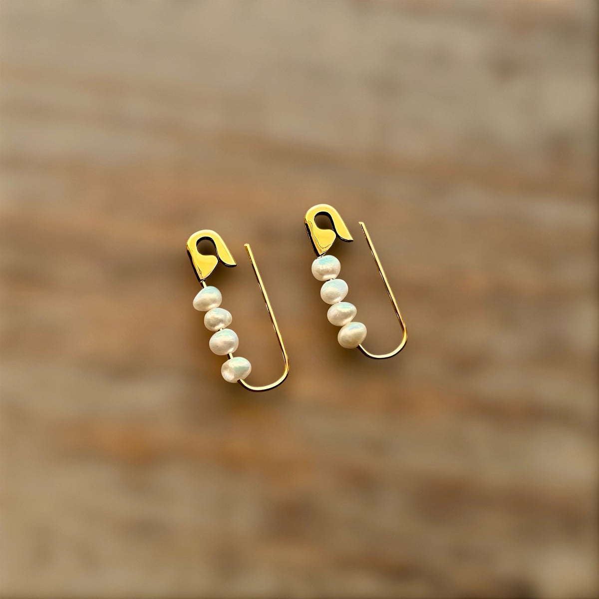 Gold-plated safety pin hoop silver earrings with five small white pearls on each, 3/4 inch length.