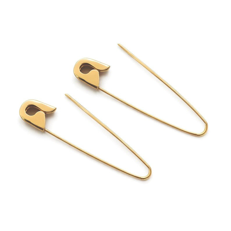 Gold plated safety pin hoop silver earrings with edgy punk design on white background , 1.25 inches long.