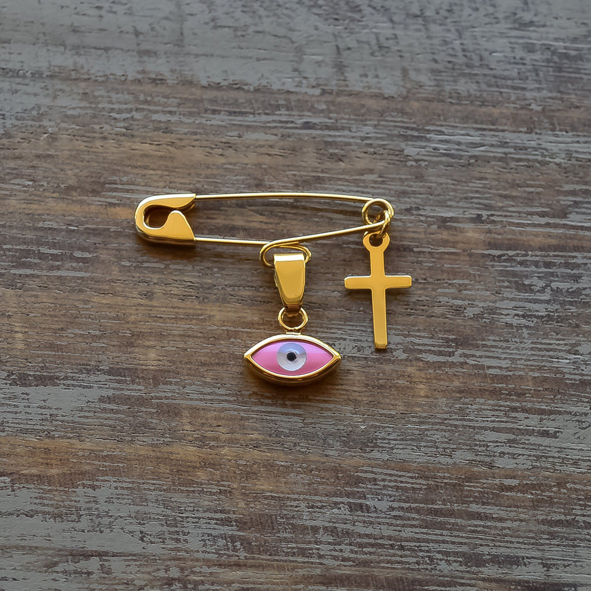 Gold Safety Pin Brooch with Evil Eye & Cross On A Wooden Surface | Baptism Gift - 24jewels