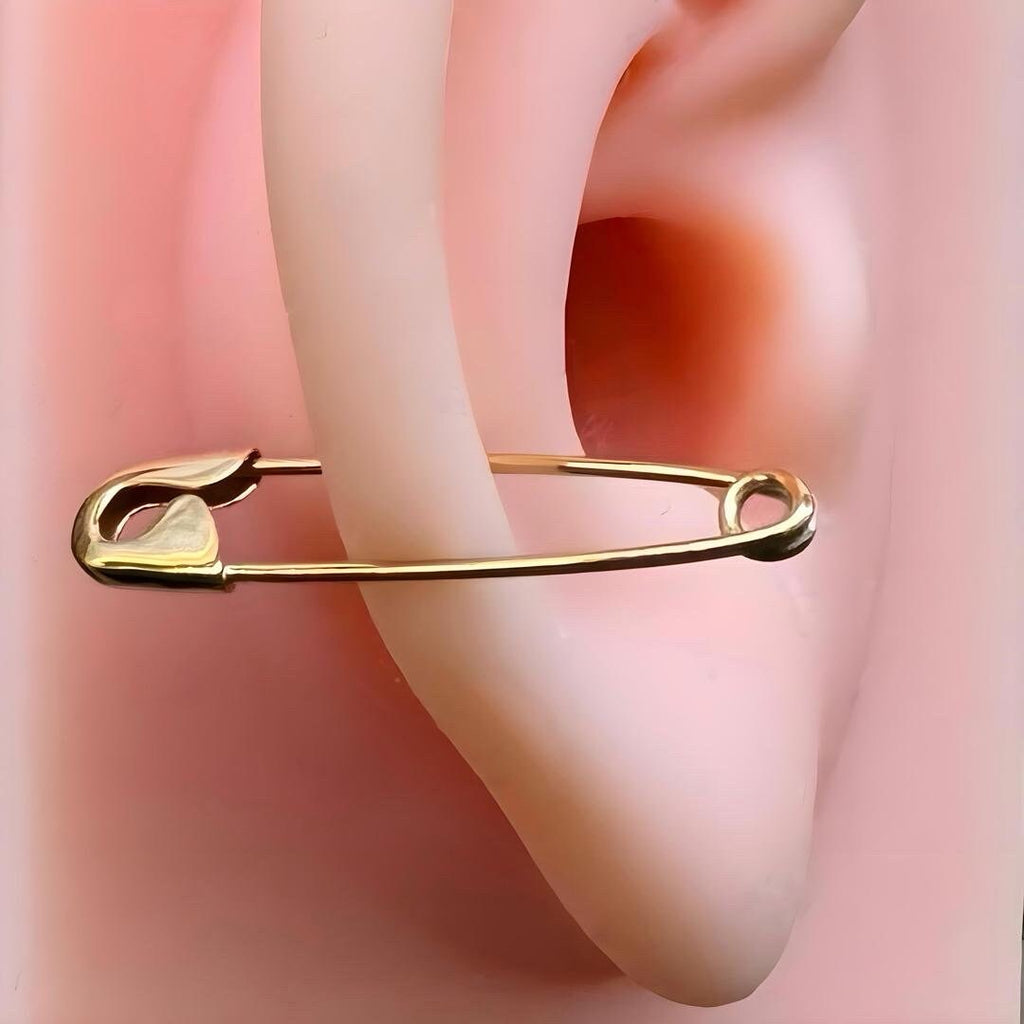 1-inch gold safety pin cartilage earring worn on ear cartilage .