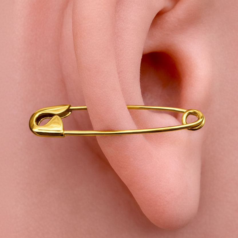 1-inch gold safety pin cartilage earring in polished yellow gold on ear.