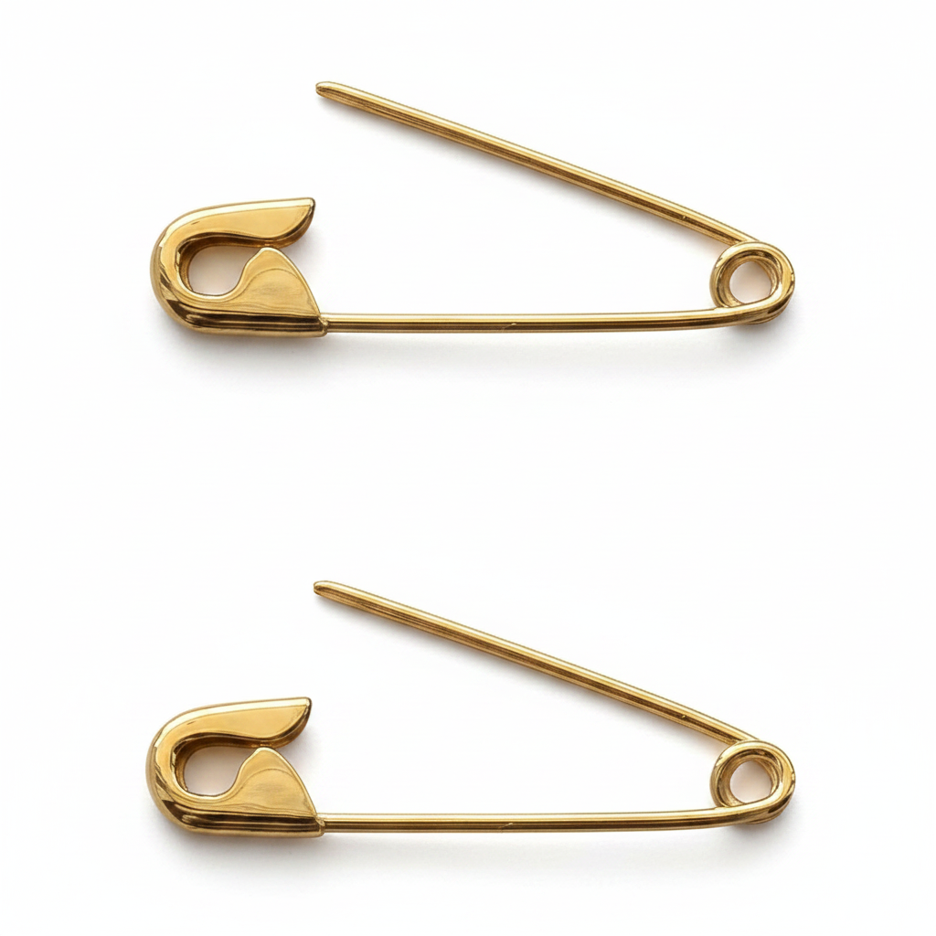 Pair of 1-inch gold safety pin cartilage earrings with smooth polished finish on white background .