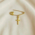 Gold Safety Pin Elegant Cross Brooch on smooth surface - 24jewels