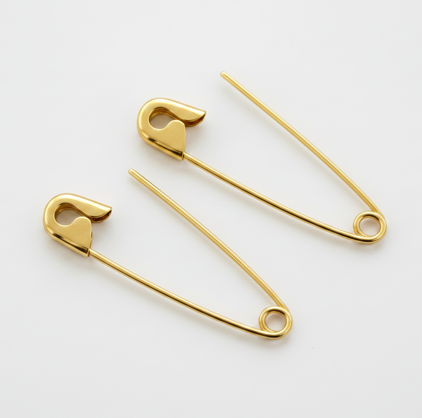Pair of 1.25-inch god safety pin earrings with polished finish on white background.
