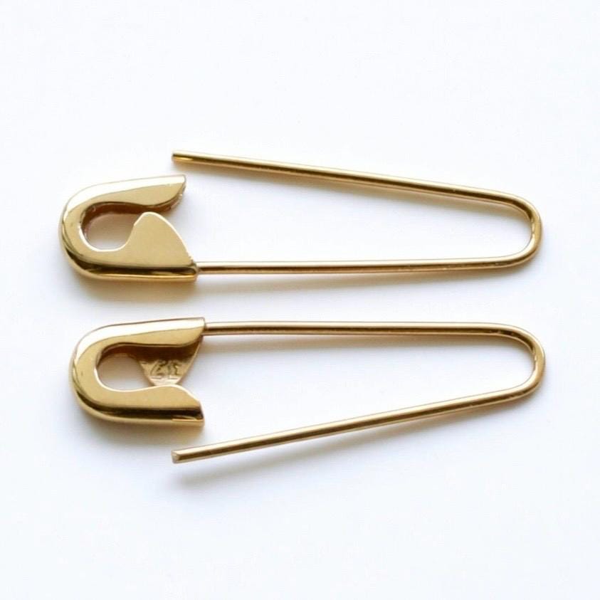 Gold-plated safety pin hoop earrings with a smooth polished finish, 1 inch length.