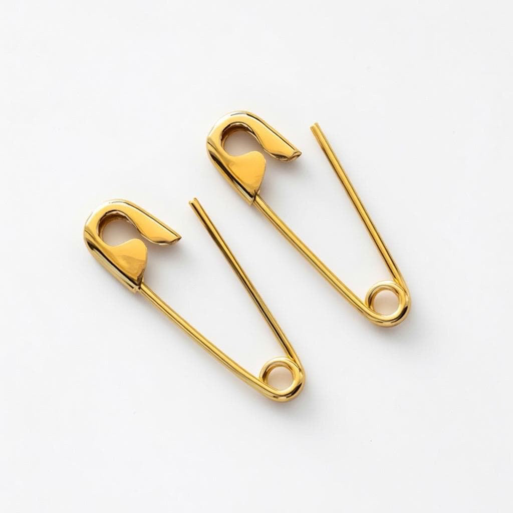 Gold plated safety pin punk earrings with minimal punk design, 3/4 inch length.