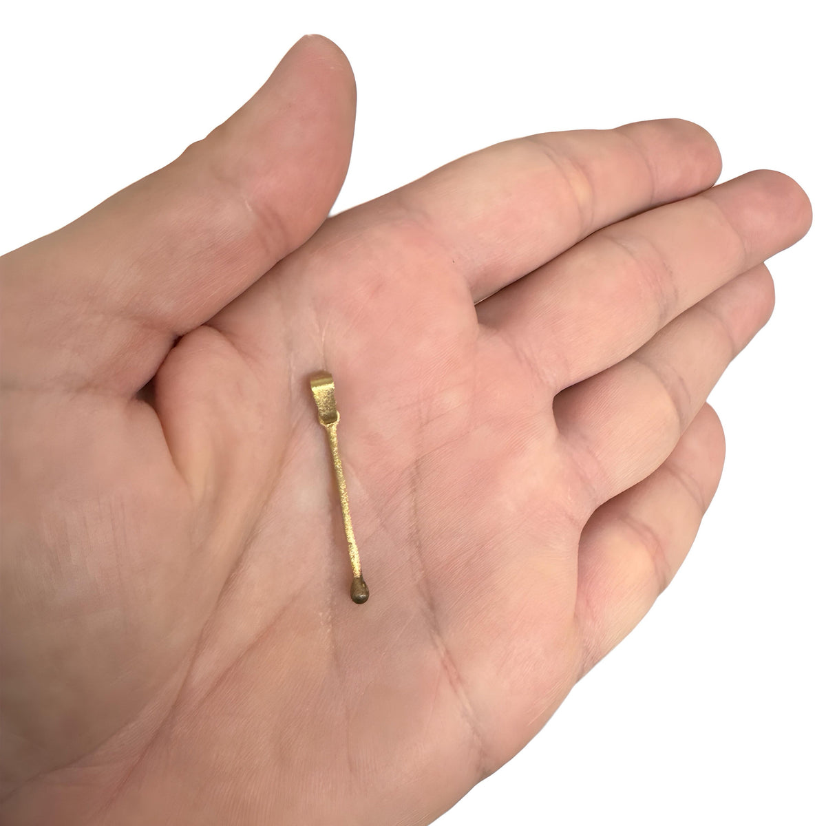 Delicate gold pendant shaped like a slender matchstick with rounded ends on a hand