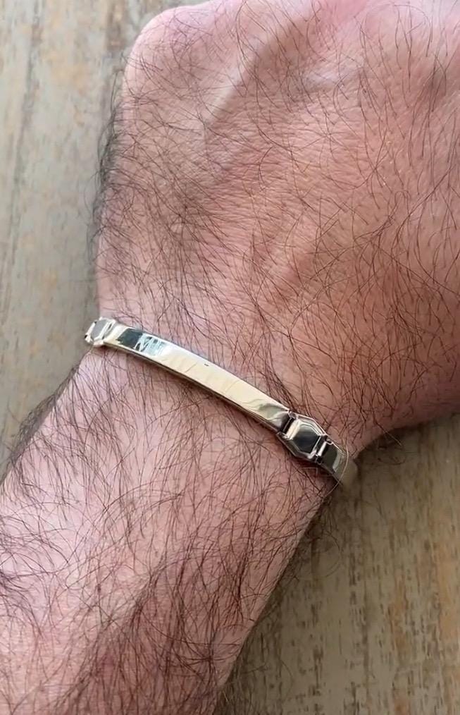 Personalized Silver Hebrew Bracelet on a man's wrist which is on a wooden surface : Men’s Wrist Band Custom Bangle Jewish Jewelry - 24jewels