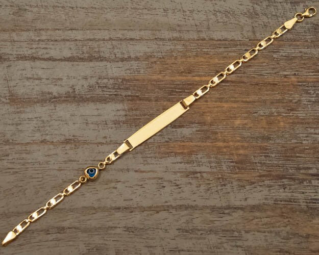 Personalized sterling silver baby bracelet gold plated with heart evil eye on wooden surface - 24jewels
