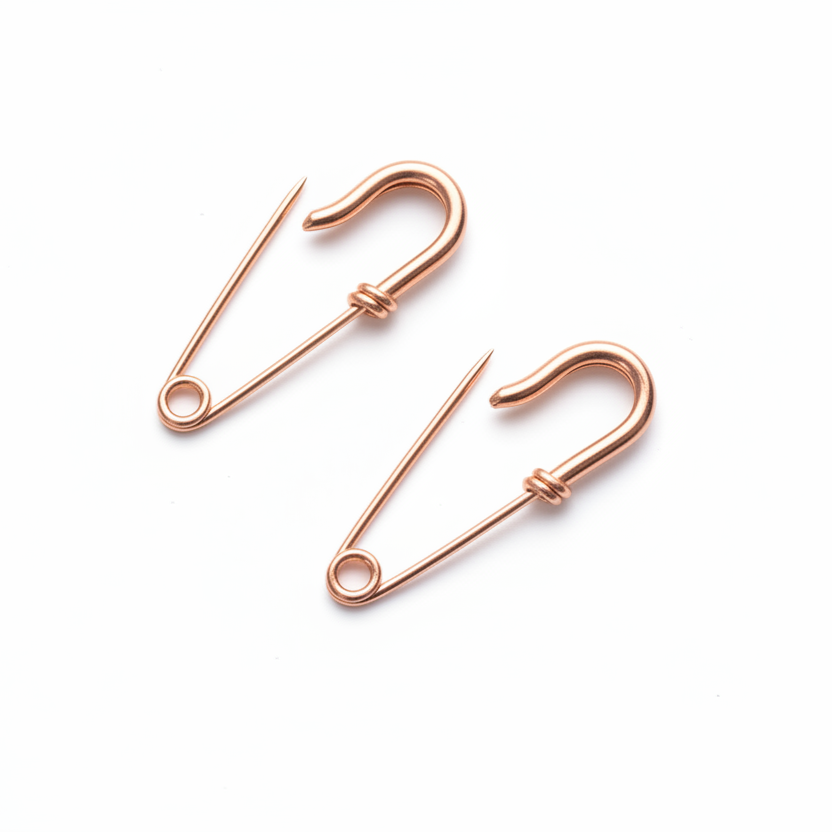 Pair of small rose gold wire safety pin earrings with minimalist, edgy design.