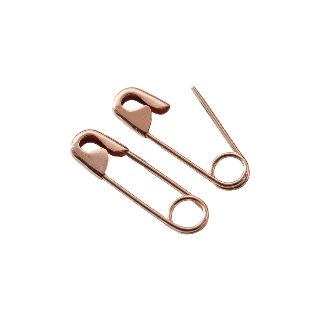 Rose gold safety pin earrings with minimalist, edgy design, 3/4 inch length.