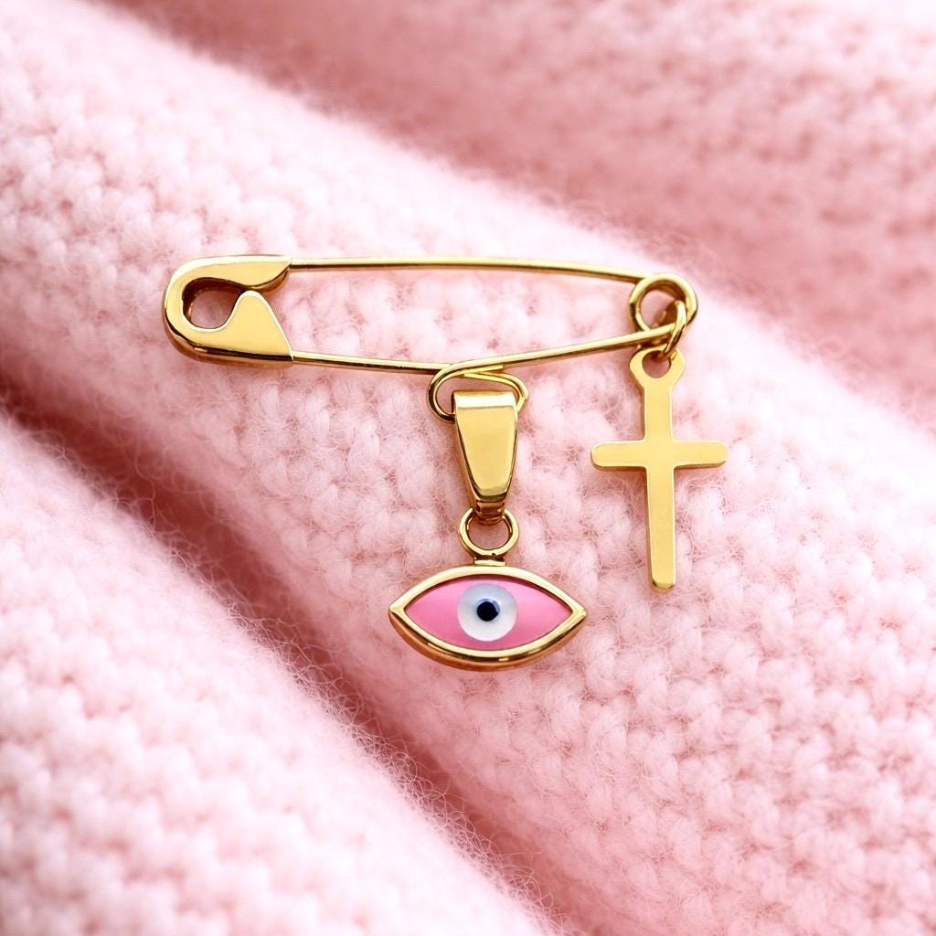 Sterling Silver Baby Safety Pin Brooch – Pink Evil Eye & Cross Gold Plated| Baptism Gift  on a soft pink blanket 