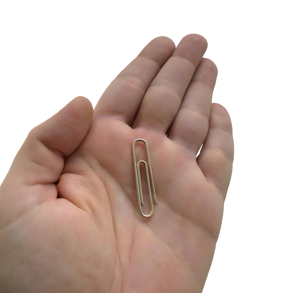 Shiny silver sterling silver paperclip money clip held in a hand, sleek minimalist design.