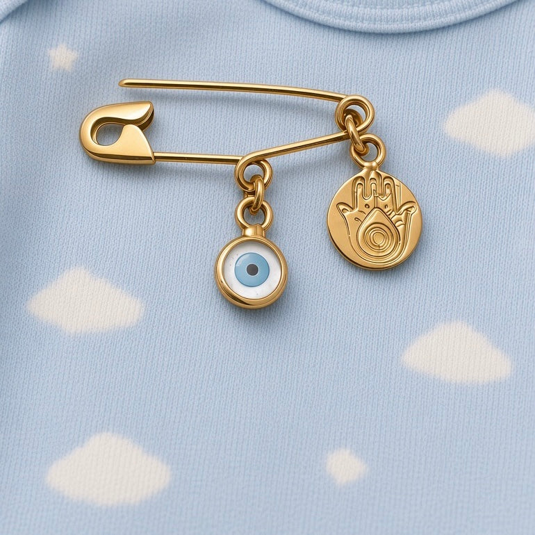 Yellow Gold Safety Pin Evil Eye Brooch With Hamsa Charm on a baby cloth - 24jewels