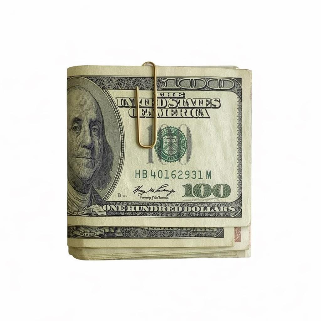 
gold paperclip money clip holding folded US $100 bills.