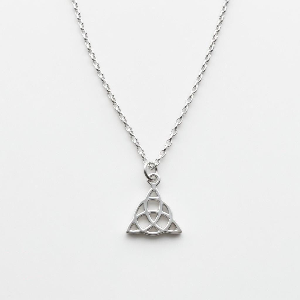 Sterling silver necklace with intricate Celtic Trinity knot pendant on delicate chain. on white background