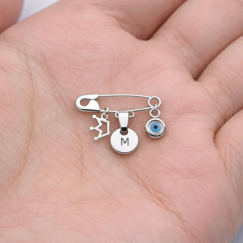 Sterling Silver Evil Eye Baby Pin Personalised Brooch With Crown Charm in a palm - 24jewels