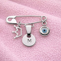 Sterling Silver Evil Eye Baby Pin Personalised Brooch With Crown Charm on a pink baby blanket - 24jewels