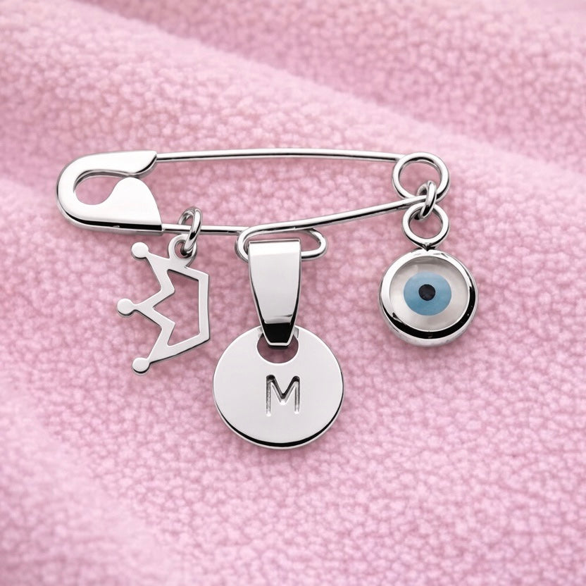 Sterling Silver Evil Eye Baby Pin Personalised Brooch With Crown Charm on a pink baby blanket - 24jewels