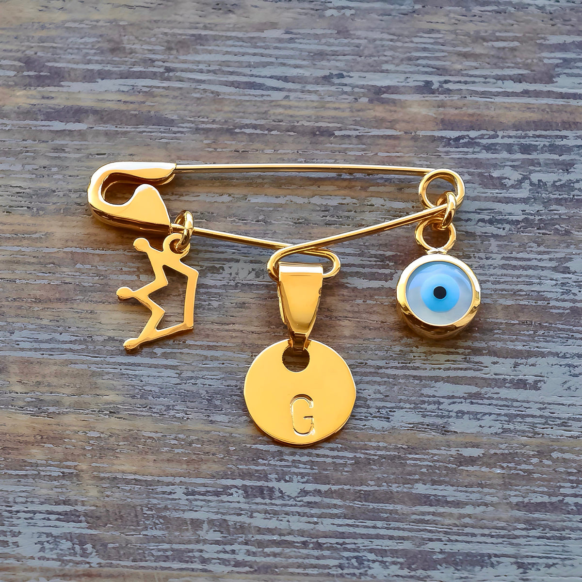 Sterling Silver Evil Eye Baby Pin Personalised Gold Plated Brooch With Crown Charm on wooden surface  - 24jewels