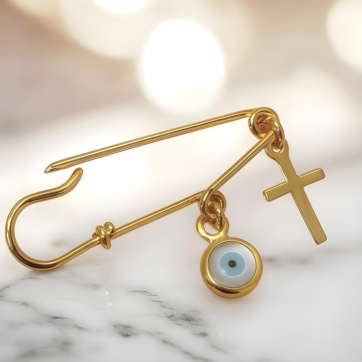Sterling Silver Evil Eye Safety Pin Baby Brooch With Cross Gold Plated on white marble surface - 24jewels