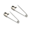 Pair of silver safety pin cartilage earrings with a smooth, polished finish on white background .