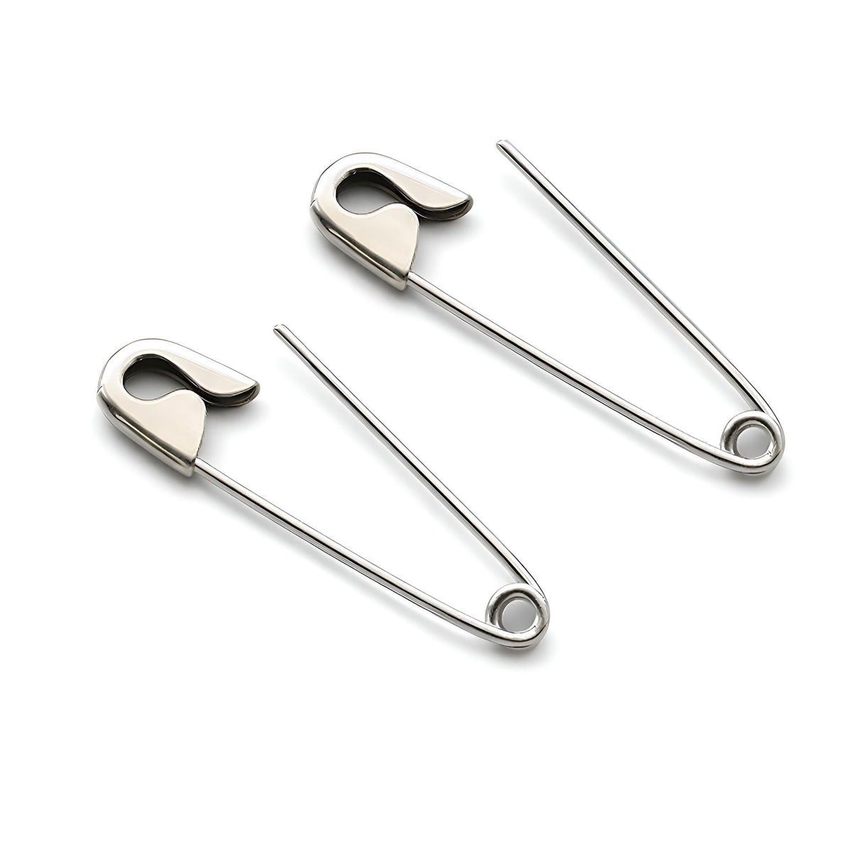 Pair of silver safety pin cartilage earrings with a smooth, polished finish on white background .