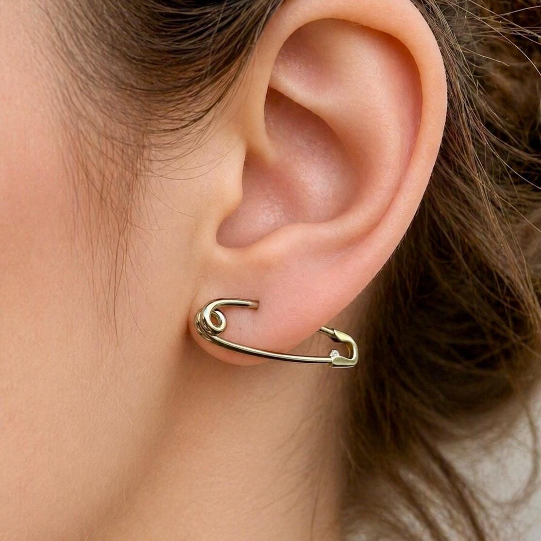 Sterling silver safety pin earring 1.3” worn on earlobe, minimalist industrial style.