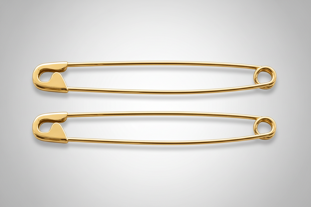 Pair of long gold-plated safety pin earrings measuring 1.75 inches on gray background.