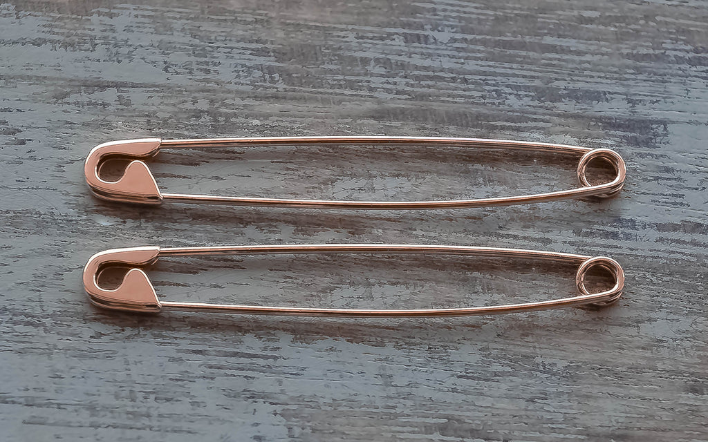 Pair of sterling silver safety pin rose gold plated earrings, slender and shiny, 1.75 inches long with classic clasp design.