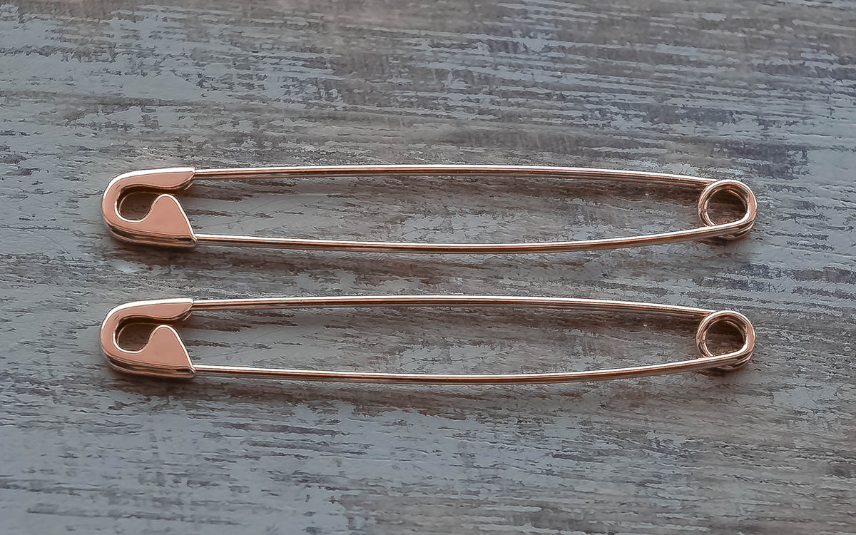 Pair of sterling silver safety pin rose gold plated earrings, slender and shiny, 1.75 inches long with classic clasp design.