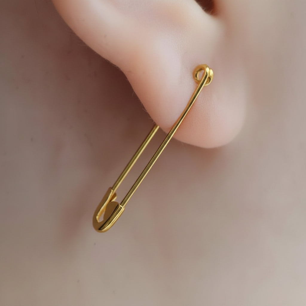 Gold plated sterling silver safety pin earring with a minimalist, elongated design measuring 1.25 inches long.