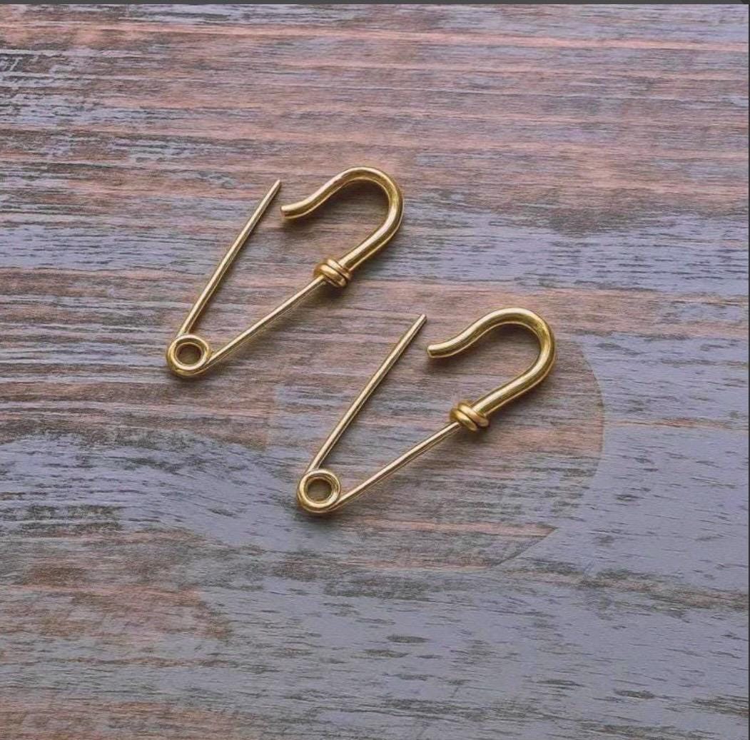 Small gold plated silver safety pin earrings with thin wire design and functional clasp closure.