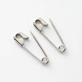 Pair of sterling silver safety pin earrings with shiny, minimalist punk design, 3/4 inch long.