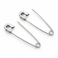 Pair of slim white gold safety pin earrings with a polished finish on white background.