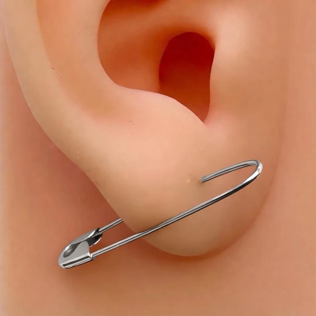 White Gold safety pin hoop earring with a minimalist, edgy design through earlobe.