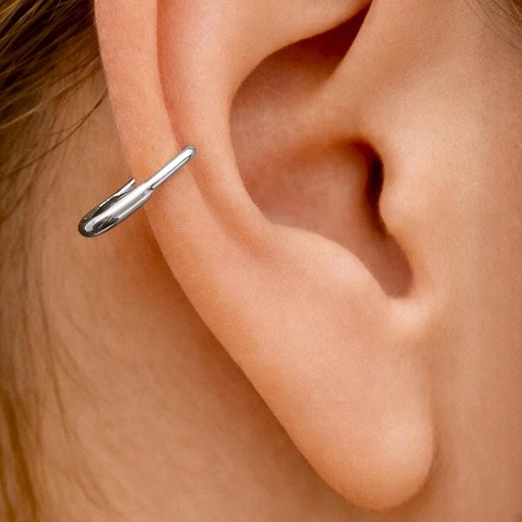 Small polished white gold mini hoop earring designed as a sleek safety pin on ear cartilage.