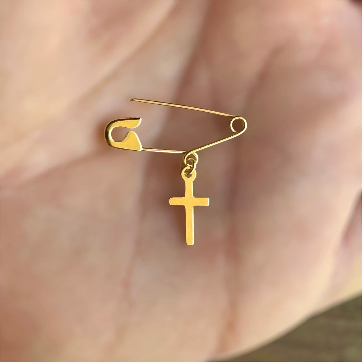Gold Safety Pin Elegant Cross Brooch on a hand - 24jewels